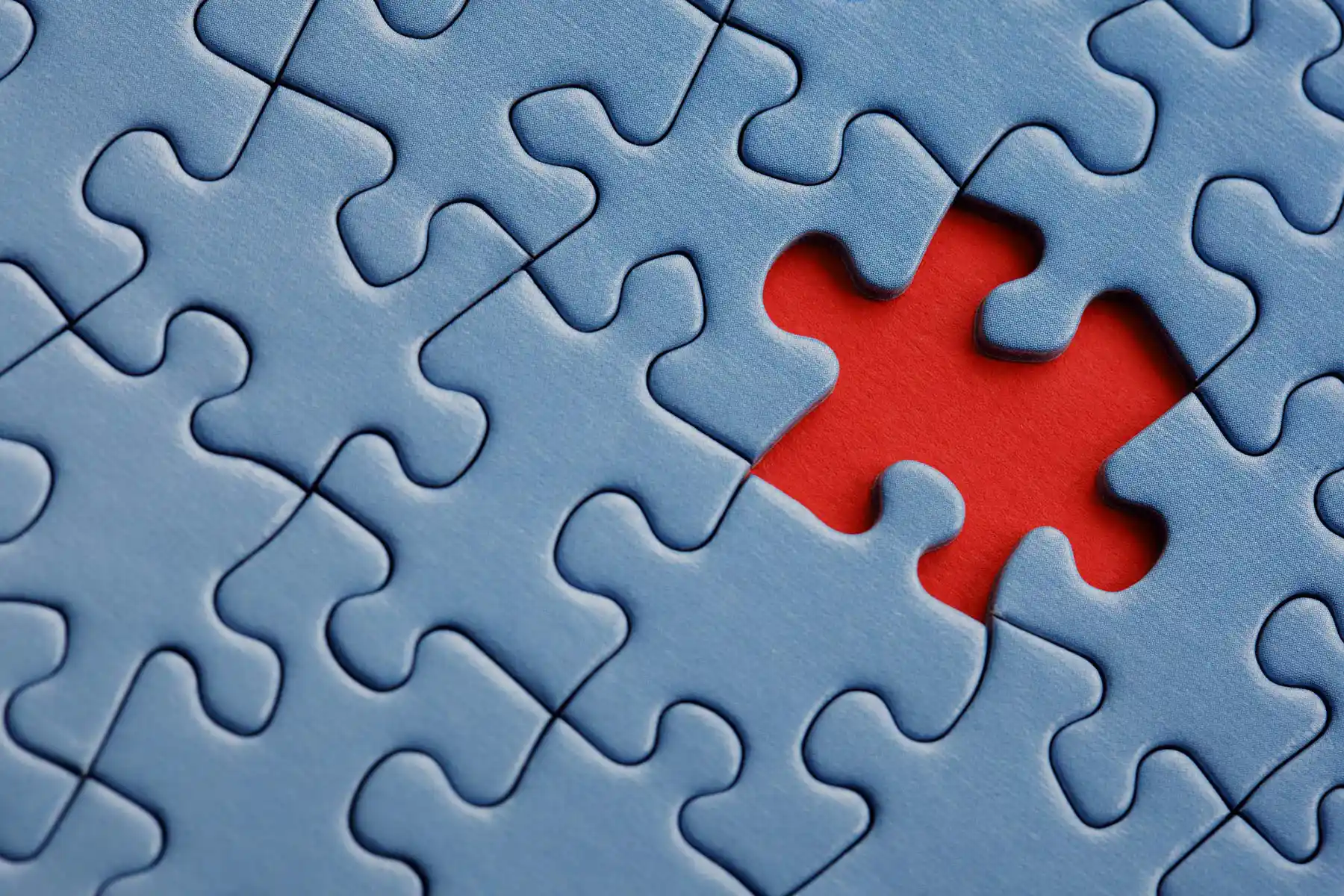 Blue puzzle pieces with a red one missing, representing philadelphia whistleblowing lawyers