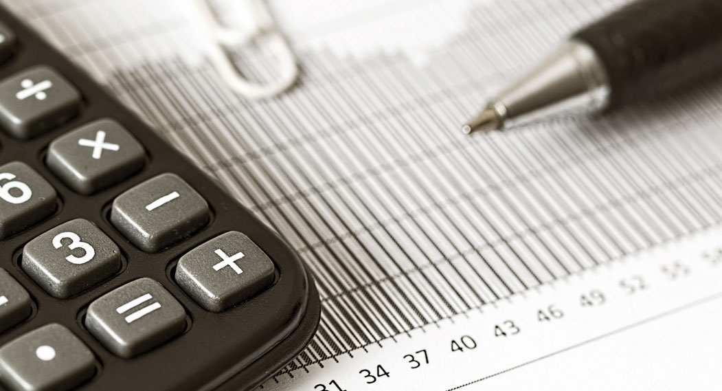 Close-up Photograph of a Calculator and a Graph Paper, representing the IRS