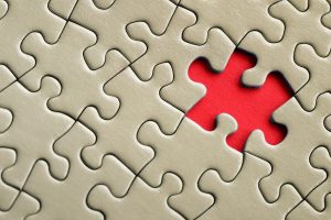 Powerful IRS Whistleblower Retaliation Protections Proposed in Senate 1 Gold Puzzle with one Red Puzzle piece, representing IRS Whistleblower Retaliation Protections