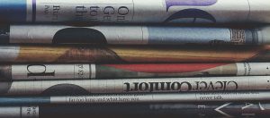 Whistleblower News 16 stack of newspapers