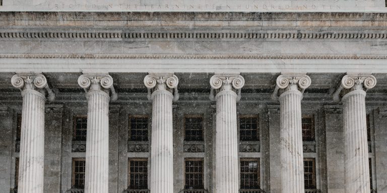 DOJ Aggressively Pursues Astounding Health Care Fraud in 2019 6 Courthouse with columns, representing Department of Justice (DOJ) and SEC Enforcement