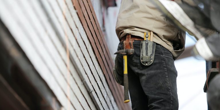 Permanent Whistleblower Protections for Federal Contractors 3 Man Wearing Black Denim Pants With Carrying Hammer on Holster, representing permanent whistleblower protections for contractors