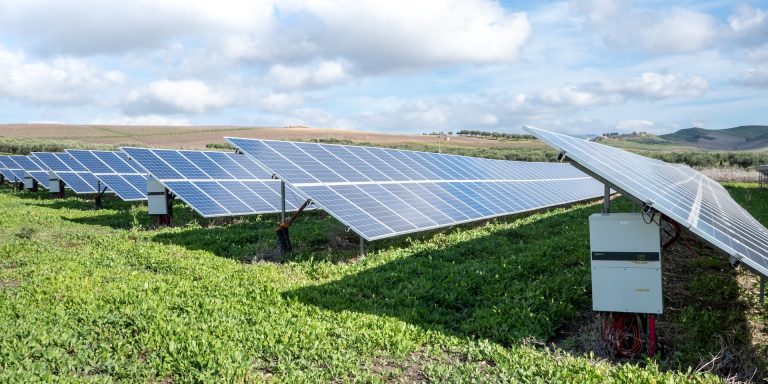 A Review of Recent Damaging Clean Energy Fraud 7 Photovoltaic PV plant ground mounted with string inverters, highlighting clean energy fraud