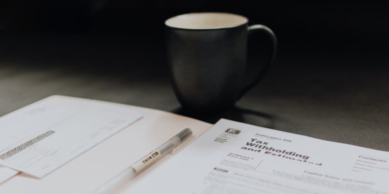 IRS Concludes 2nd Successful Offshore Voluntary Disclosure Initiative 8 Accounting pages and a coffee mug, representing internal and external audits