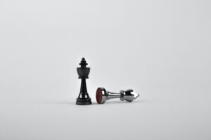 Whistleblower News 9 Battle - Two Silver Chess Pieces on White Surface
