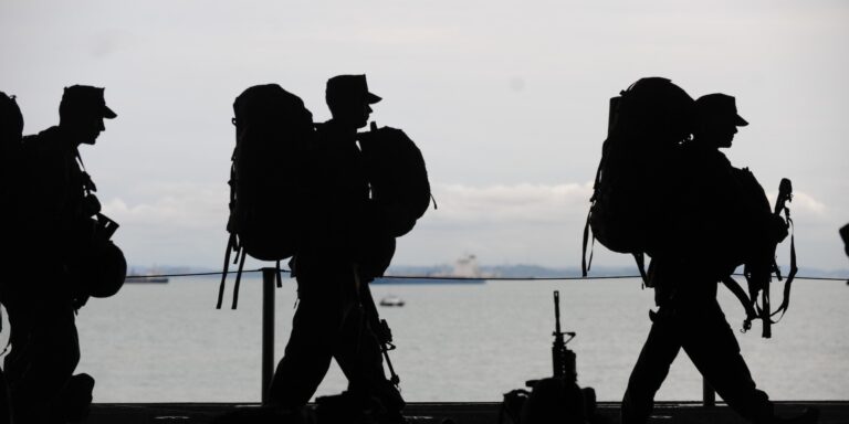 Military Contractors: Big Bucks, Big Fraud 4 Silhouette of Soldiers Walking, representing military contractors