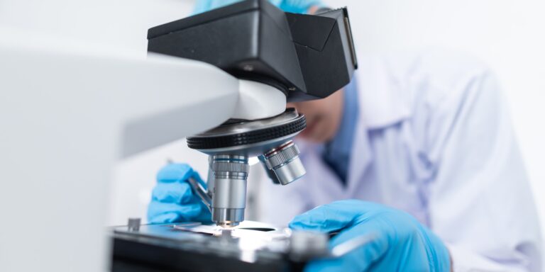 Recent Qui Tam Cases Part 1: Medicare and Medicaid 6 Closeup of Scientist Looking Through Microscope in a Lab - for article on Novartis