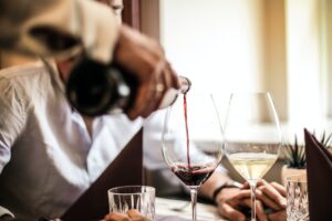 Whistleblower News 8 Crop man pouring red wine in glass in restaurant