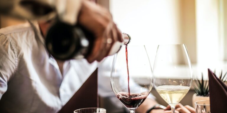 Service Industry Employees 4 Crop man pouring red wine in glass in restaurant